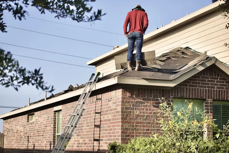 Professional roofer working on a residential roof in Hayti